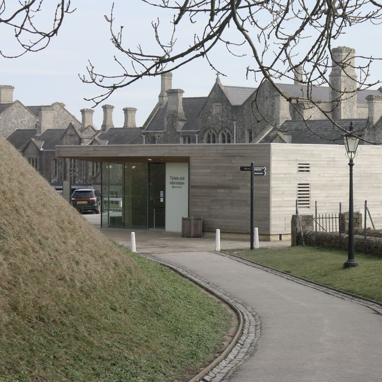 Dover Castle, a low timber-clad visitor building set into a grass bank
