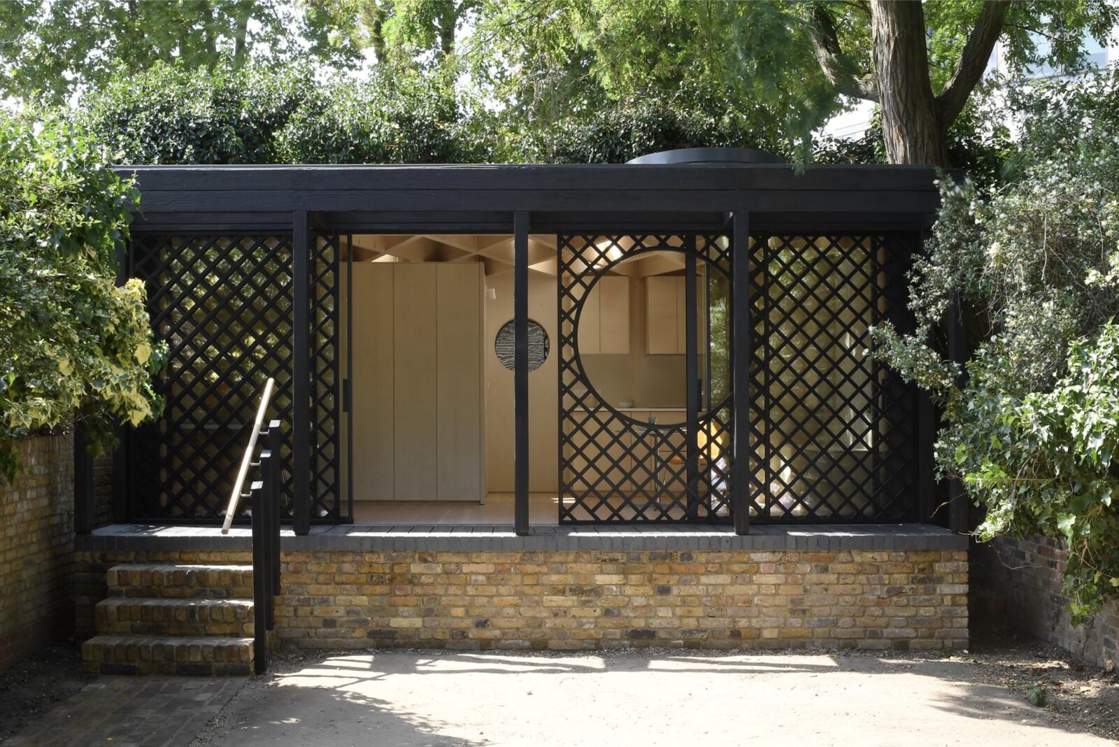 The completed Garden Room, a charred timber garden annex at Stockwell Park Road